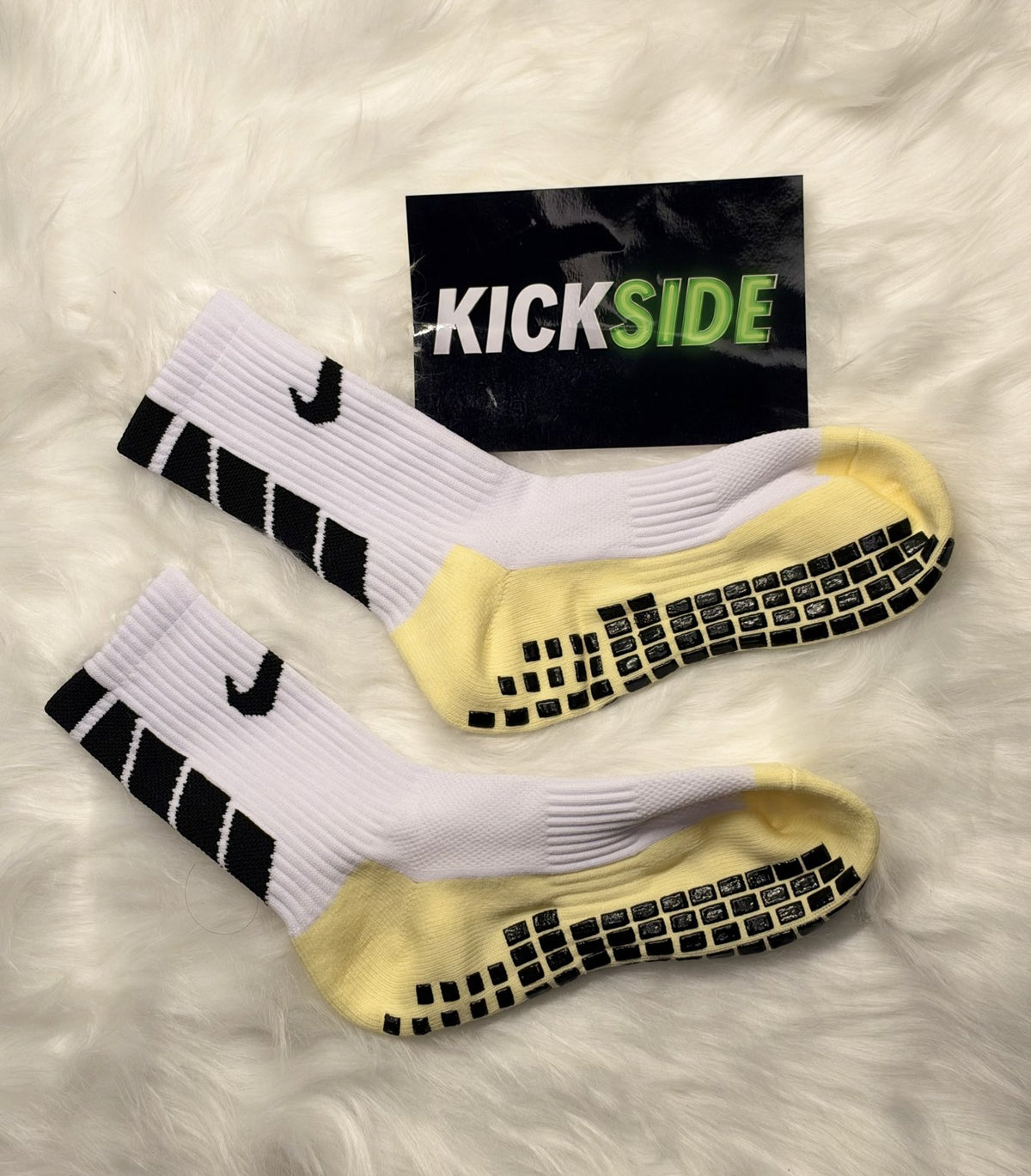 White Nike-style football grip socks with yellow footbed and black grip pads
