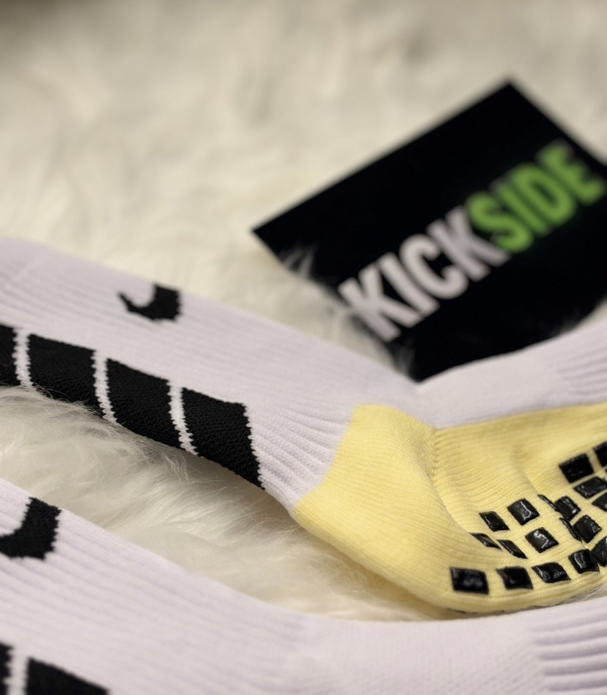 Close-up of the rubber grip pads on a yellow sock sole