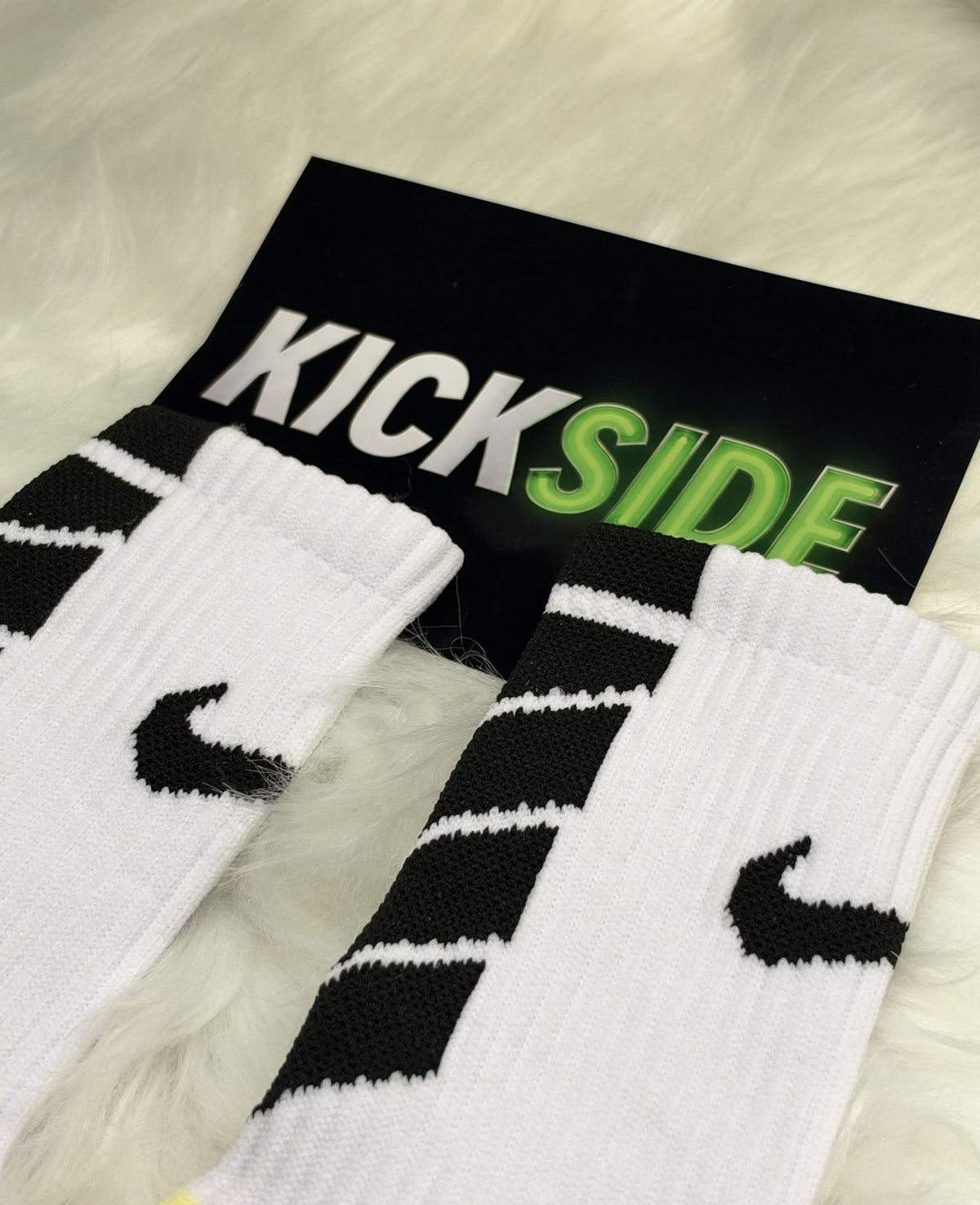 Close-up of the cuff and logo on white football grip socks